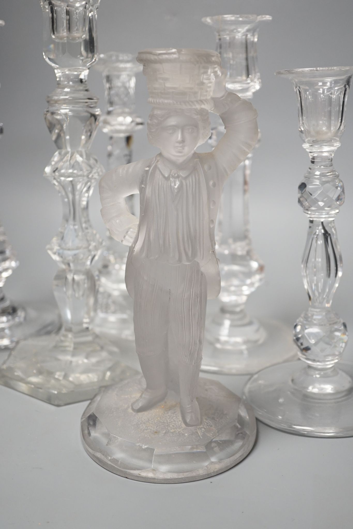 Five various cut glass candlesticks, a pair of John Ford, Holyrood Glass Works, Edinburgh figural frosted glass candlesticks and a lustre drop bag chandelier